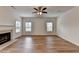 Bright living room featuring a fireplace and hardwood floors at 2421 Fall Creek Lndg, Loganville, GA 30052