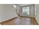Bright living room featuring stairs, hardwood floors, and natural light from the window at 2421 Fall Creek Lndg, Loganville, GA 30052