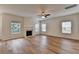 Bright living room with fireplace, neutral walls, and hardwood floors at 2421 Fall Creek Lndg, Loganville, GA 30052
