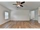 Spacious living room with wood floors, ceiling fan, open layout, and easy access to other rooms at 2421 Fall Creek Lndg, Loganville, GA 30052