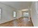 Spacious living room with laminate floors, crown molding, and large windows for natural light at 2421 Fall Creek Lndg, Loganville, GA 30052
