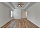 Main bedroom features tray ceiling, a ceiling fan, and wood-look flooring at 2421 Fall Creek Lndg, Loganville, GA 30052