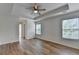 A bright main bedroom with a tray ceiling, ceiling fan, and windows with views at 2421 Fall Creek Lndg, Loganville, GA 30052