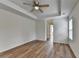 Main bedroom featuring wood-look flooring, white walls, tray ceiling, and a ceiling fan at 2421 Fall Creek Lndg, Loganville, GA 30052