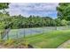 Outdoor tennis courts with surrounding greenery and lighting at 2421 Fall Creek Lndg, Loganville, GA 30052