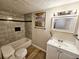 Well-lit bathroom featuring a tiled shower/tub, modern vanity, and stylish mirror at 2977 5Th St, Atlanta, GA 30315