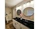 Modern bathroom featuring dual sinks, sleek black countertops, and contemporary fixtures, with great lighting at 2977 5Th St, Atlanta, GA 30315
