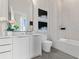 Modern bathroom features white vanity, large mirror, and separate bathtub with tile surround at 40 12Th St # 1004, Atlanta, GA 30309