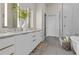 Serene bathroom featuring double vanity, modern shower and free-standing tub at 40 12Th St # 1004, Atlanta, GA 30309