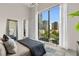 Bright bedroom with a large window showcasing a city view, modern furniture, and natural light at 40 12Th St # 1004, Atlanta, GA 30309