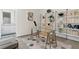 Modern home office with glass top desk, shelves filled with books and bath in the background at 40 12Th St # 1004, Atlanta, GA 30309