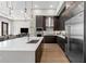 The kitchen has a large center island, stainless steel appliances, and dark wood cabinetry at 40 12Th St # 1004, Atlanta, GA 30309