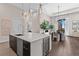 Open kitchen boasts a large island with sink, stainless steel appliances, and adjacent dining area at 40 12Th St # 1004, Atlanta, GA 30309