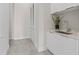 Bright laundry room features a stainless steel sink, white cabinets, and tile floors at 40 12Th St # 1004, Atlanta, GA 30309