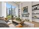 Beautiful city views from this contemporary living room, featuring designer decor and hardwood floors at 40 12Th St # 1004, Atlanta, GA 30309