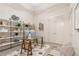 A bright home office featuring built-in shelving, a glass desk, and neutral tones at 40 12Th St # 1004, Atlanta, GA 30309