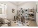 Bright home office with a glass desk, stylish shelving, and adjacent bathroom at 40 12Th St # 1004, Atlanta, GA 30309