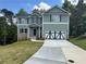 Charming two-story home with a well-maintained lawn, brick accents, and a stylish garage door at 66 Pine Creek Ct, Dallas, GA 30157