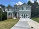 Charming two-story home with green siding, dark shutters, and a two-car garage at 66 Pine Creek Ct, Dallas, GA 30157