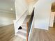 Bright staircase with wood and white accents, featuring carpet steps at 66 Pine Creek Ct, Dallas, GA 30157