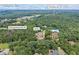 Aerial view showcases a luxurious home, pond and wooded land, pinpointing key locations in Auburn, GA at 1005 Renfroe Lake Dr, Auburn, GA 30011
