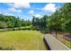 A serene backyard view with lush greenery, landscaping, and a tranquil pond for outdoor relaxation at 1005 Renfroe Lake Dr, Auburn, GA 30011