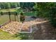 Scenic backyard landscaping leading down to a tranquil lake with stone steps and lush greenery at 1005 Renfroe Lake Dr, Auburn, GA 30011