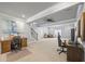 Finished basement with multiple workspaces, modern ceiling fan, and natural light at 1005 Renfroe Lake Dr, Auburn, GA 30011