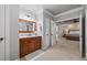 This bathroom leads to the bedroom and showcases a vanity with a granite countertop and a framed mirror at 1005 Renfroe Lake Dr, Auburn, GA 30011