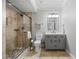 Bathroom featuring walk-in shower with river rock base, a gray vanity, and neutral tile at 1005 Renfroe Lake Dr, Auburn, GA 30011