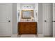 This bathroom features a beautiful vanity with a granite countertop and a framed mirror at 1005 Renfroe Lake Dr, Auburn, GA 30011