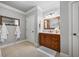 View of the bathroom, showcasing tile floors, a vanity with a granite countertop, and a framed mirror at 1005 Renfroe Lake Dr, Auburn, GA 30011