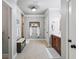 View of the large bathroom, showcasing tile floors, a vanity with a granite countertop, and a framed mirror at 1005 Renfroe Lake Dr, Auburn, GA 30011