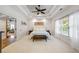 Spacious bedroom with neutral carpet features a decorative ceiling and access to other rooms at 1005 Renfroe Lake Dr, Auburn, GA 30011