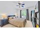 Bedroom featuring a ceiling fan, dresser, and decorative items at 1005 Renfroe Lake Dr, Auburn, GA 30011