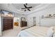 Bright bedroom with neutral carpet features a TV, storage, and bathroom access at 1005 Renfroe Lake Dr, Auburn, GA 30011