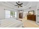 Bedroom with ensuite bathroom features a TV, neutral carpet and a decorative ceiling at 1005 Renfroe Lake Dr, Auburn, GA 30011