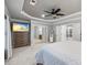This bedroom features modern ceiling fan, with easy access to the Primary bathroom and lovely beach themed TV at 1005 Renfroe Lake Dr, Auburn, GA 30011
