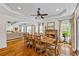 Dining room with hardwood floors and a stone fireplace connects to the living room at 1005 Renfroe Lake Dr, Auburn, GA 30011