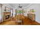 Dining room with hardwood floors features a stone fireplace and outdoor views at 1005 Renfroe Lake Dr, Auburn, GA 30011