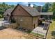 Exterior view of home with lush greenery, fenced-in yard, a deck with patio furniture, and a driveway at 1005 Renfroe Lake Dr, Auburn, GA 30011