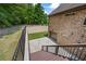 Exterior view of the home with stairs leading down to a two car garage and a fenced in backyard at 1005 Renfroe Lake Dr, Auburn, GA 30011