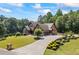 Stunning home featuring a long driveway, lush lawn, beautiful landscaping and an attached garage at 1005 Renfroe Lake Dr, Auburn, GA 30011