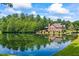 View of the back of the house near the lake surrounded by mature trees at 1005 Renfroe Lake Dr, Auburn, GA 30011