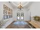 Bright foyer features a beautiful light fixture, tiled floor, and stylish decor, creating a warm welcome at 1005 Renfroe Lake Dr, Auburn, GA 30011