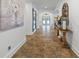 Spacious foyer with decorative table and decor, tile flooring, and view of double front doors at 1005 Renfroe Lake Dr, Auburn, GA 30011