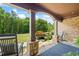 View of the covered front porch with rocking chairs and stone pillars, perfect for relaxing outdoors at 1005 Renfroe Lake Dr, Auburn, GA 30011