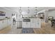 Well-equipped kitchen featuring white cabinetry, stainless steel appliances, and a large central island at 1005 Renfroe Lake Dr, Auburn, GA 30011