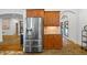 Close-up of stainless steel refrigerator and cabinetry with granite countertops and tile backsplash at 1005 Renfroe Lake Dr, Auburn, GA 30011