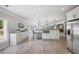 Bright eat-in kitchen with an island, stainless steel appliances, and white cabinets and drawers at 1005 Renfroe Lake Dr, Auburn, GA 30011